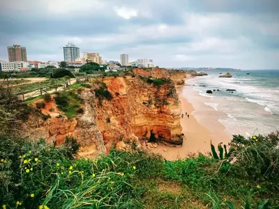 a view of a beach with a cliff at Casa Esmarand in Albufeira
