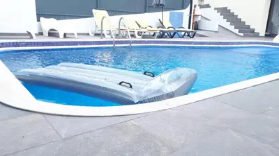 a raft in the middle of a swimming pool at Marina Vila Apartment with Pool in Albufeira