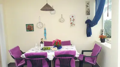 a dining room with a table with purple chairs at Marina Vila Apartment with Pool in Albufeira
