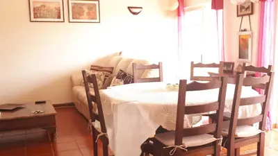 a living room with a table and a couch at Marina Vila Apartment with Pool in Albufeira