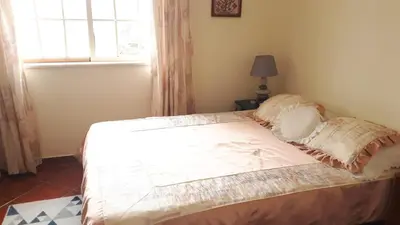 a bed in a bedroom with a window at Marina Vila Apartment with Pool in Albufeira
