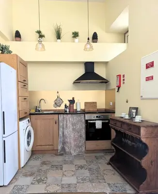 a kitchen with a sink and a stove top oven at Grand studio 29 in Faro