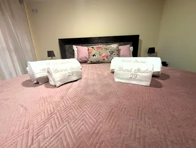 two pillows on a bed with a pink blanket at Grand studio 29 in Faro