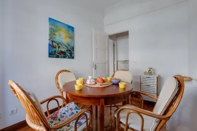 a dining room with a wooden table and chairs at Casa LOTUS - Requinte e bom gosto para 6 pessoas no coração de Faro in Faro