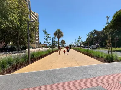 a group of people walking down a sidewalk at Discovery Apartment Vilamoura in Vilamoura
