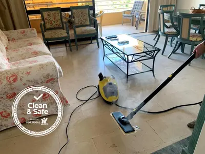 a vacuum cleaner on the floor in a living room at Discovery Apartment Vilamoura in Vilamoura