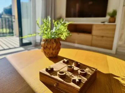 a wooden box sitting on a table with a vase at Birdie Bliss Apartment - CleverDetails - Sleeps 4 Adults and 1 Child in Vilamoura