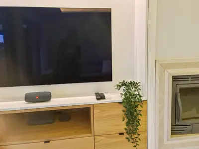 a large flat screen tv sitting on top of a cabinet at Birdie Bliss Apartment - CleverDetails - Sleeps 4 Adults and 1 Child in Vilamoura