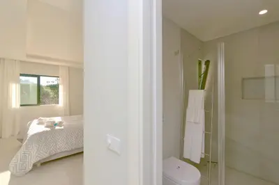 a bathroom with a bed and a glass shower at Birdie Bliss Apartment - CleverDetails - Sleeps 4 Adults and 1 Child in Vilamoura