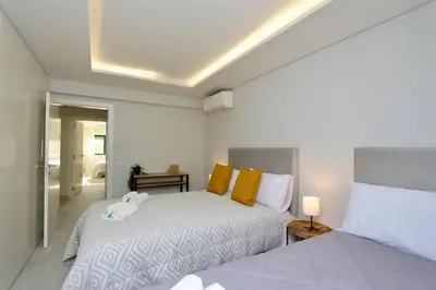a bedroom with two beds next to each other at Birdie Bliss Apartment - CleverDetails - Sleeps 4 Adults and 1 Child in Vilamoura