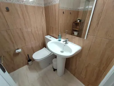 a bathroom with a white sink and a toilet at Casa da Madalena in Faro
