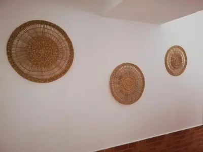 three wicker baskets hanging on a white wall at Casa da Madalena in Faro