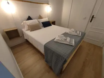 a bedroom with a bed with two towels on it at Casa da Madalena in Faro