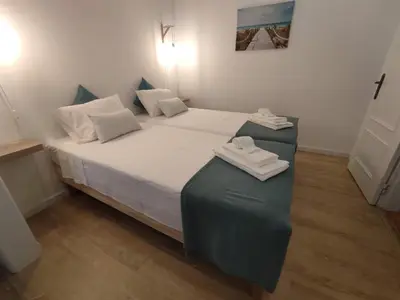 a bedroom with a large bed with two tables at Casa da Madalena in Faro