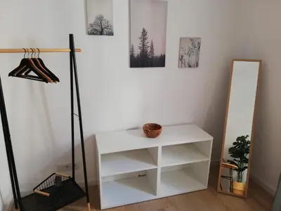 a room with a white shelf and a mirror at Casa da Madalena in Faro