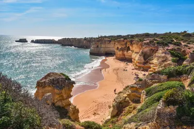 an aerial view of a house with the ocean in the background at Beach villa Casa de Amanhã 450 mts to the beach with beautiful garden and heated saltwater pool in Albufeira