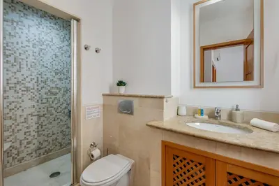 a living room with a couch and a tv at Sunshine Vista Apartment Vilamoura in Vilamoura