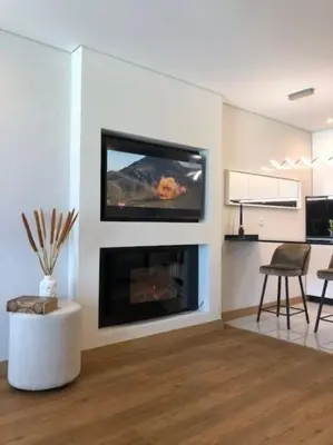 a living room with a fireplace with a flat screen tv at Vilamoura Sunrise in Quarteira