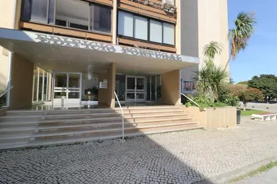 a building with a sign on the front of it at Vilamoura Sunrise in Quarteira