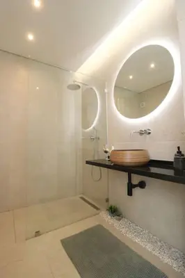 a bathroom with a shower with a sink and a mirror at Vilamoura Sunrise in Quarteira