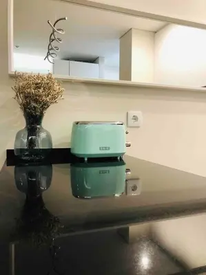 a coffee maker sitting on a table with a vase at Vilamoura Sunrise in Quarteira