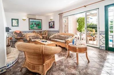 a living room with couches and tables at Villa Silveira in Vilamoura