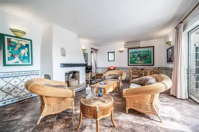 a living room filled with furniture and a fireplace at Villa Silveira in Vilamoura