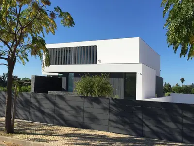 a white house with a black fence in front of it at Villa Algarve Paradise in Vilamoura