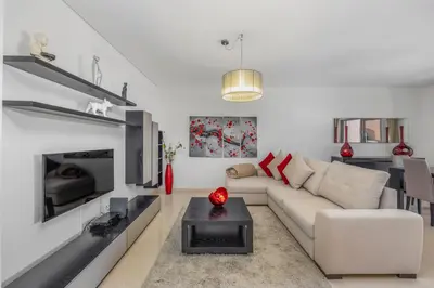 a living room with a couch and a fireplace at Pine Garden Apartment Vilamoura in Vilamoura