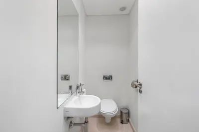 a white bathroom with a sink and a toilet at Pine Garden Apartment Vilamoura in Vilamoura