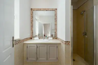 a bathroom with a sink and a mirror at Villa Grace in Almancil