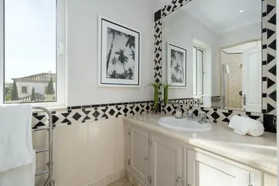 a bathroom with a sink and a mirror at Villa Grace in Almancil
