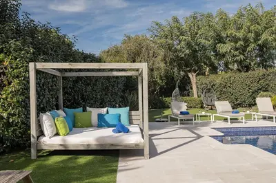 a gazebo with pillows on it next to a pool at Villa Grace in Almancil