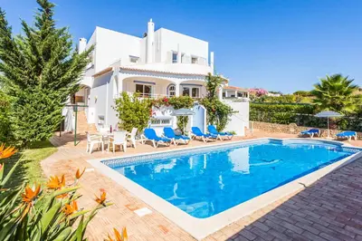 a villa with a swimming pool in front of a house at Villa Katharina in Albufeira