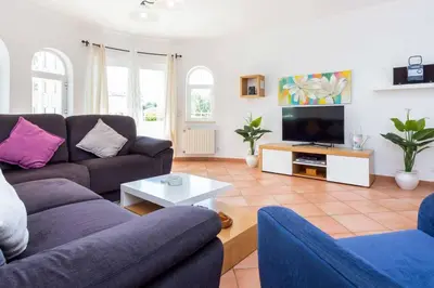 a living room with two couches and a tv at Villa Katharina in Albufeira