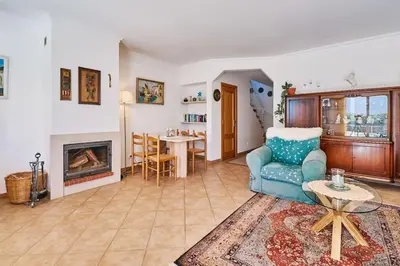 a living room with a blue couch and a fireplace at Casa Felix mit Pool in Albufeira