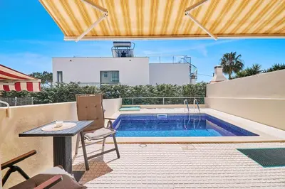a backyard with a swimming pool and a table and chairs at Casa Felix mit Pool in Albufeira