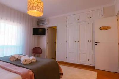 a bedroom with a bed with two towels on it at Sweet Formosa View in Faro