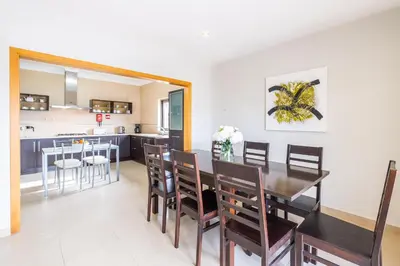 a dining room and kitchen with a table and chairs at Villa Aica - BY BEDZY in Guia