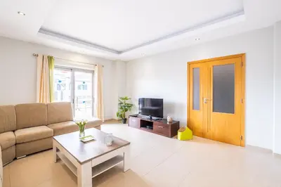 a living room with a couch and a tv at Villa Aica - BY BEDZY in Guia