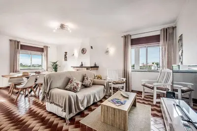a living room with a couch and a table at Casa Miranda in Albufeira