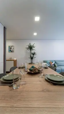 a long wooden table with plates and wine glasses at be Unforgettable Apartment in Faro