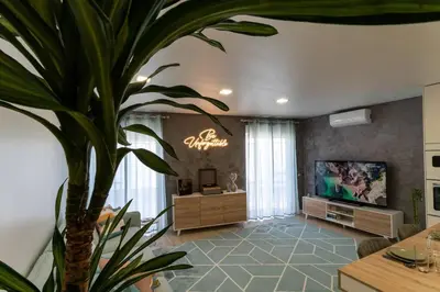 a living room with a potted plant and a television at be Unforgettable Apartment in Faro