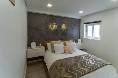 a bedroom with a large white bed and a window at be Unforgettable Apartment in Faro