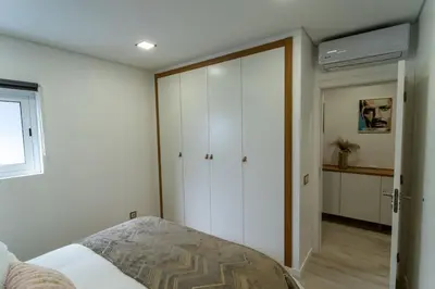 a bedroom with a bed and a sliding door at be Unforgettable Apartment in Faro