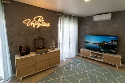 a living room with a flat screen tv on a wall at be Unforgettable Apartment in Faro