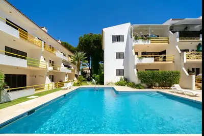 a swimming pool in front of a building at Sal da Viana, Modern Ground Floor, Vilamoura in Vilamoura
