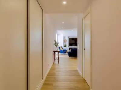 a hallway leading to a living room with white walls at AL - Vilamoura Top Floor in Vilamoura