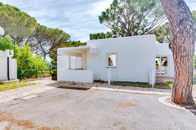 a white house with a tree in front of it at AL - Vila Barreira, near the golf in Vilamoura