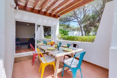 a dining room with a table and chairs on a patio at AL - Vila Barreira, near the golf in Vilamoura